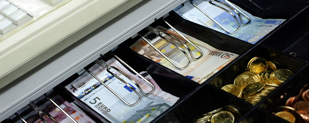Euro notes and coins in cash register